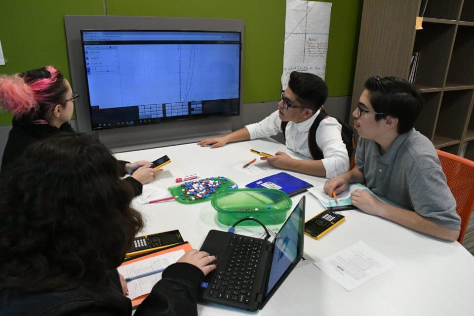 CAST Tech Algebra students use a collaborative table to model parabolic behavior, courtesy photo.