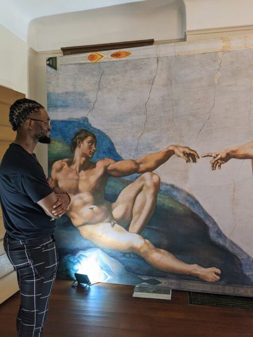 Uchennayaogba Ogba views one of the most well-known works from the Sistine Chapel exhibition. Photo credit: Iris Gonzalez.